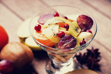 Fresh fruit salad, anise and fruits on wooden table 