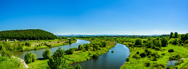 Panorama na rzekę Wisłę w oddali miasteczko Skawina. - obrazy, fototapety, plakaty