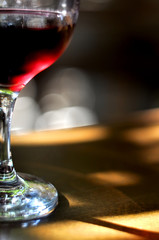 glass of red wine on the table in restaurant interior