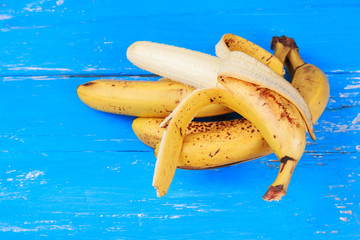 Ripe bananas on old blue painted wooden table