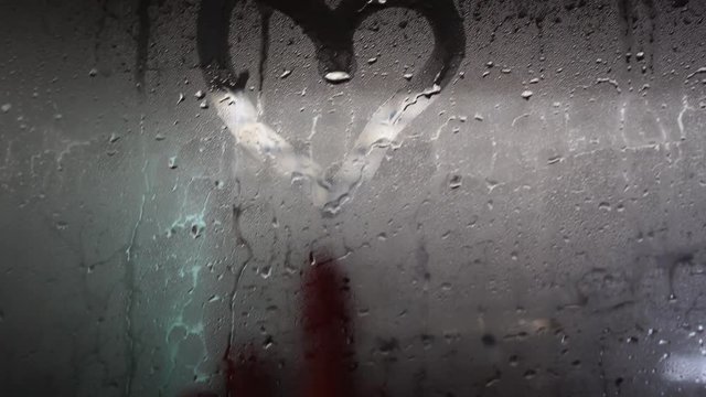 Hand Drawing a Heart on a Foggy Mirror 