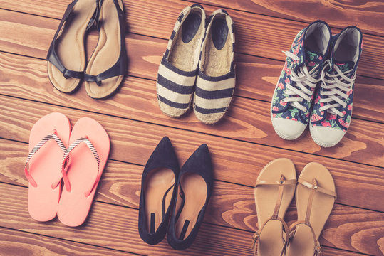 Female shoes collection on wooden background