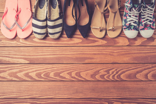 Female Shoes Collection On Wooden Background