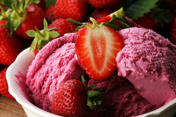 Strawberry ice cream on brown wood background