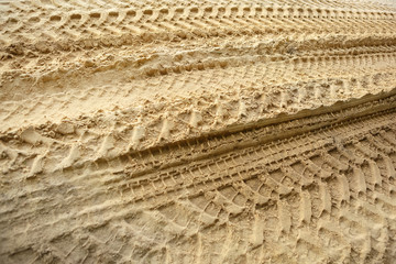 Tire tracks on the sand. Trace of wheels on the sand