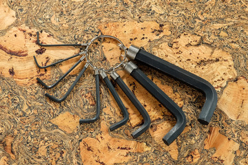 Set of steel hexagon keys / set of hexagon buttons on a wooden background