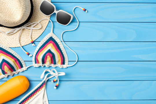Beach accessories on blue wooden background