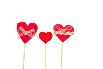 Two hearts on a wooden stick on a white background.