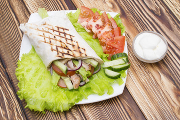 Shawarmas on lettuce isolated a wooden background
