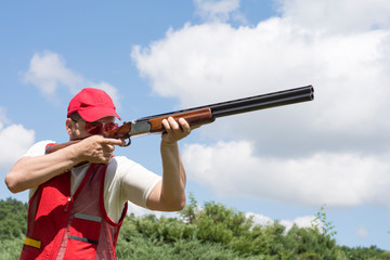 Man shooting skeet with a shotgun