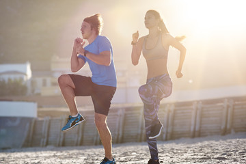 Couple Exercising On Beach