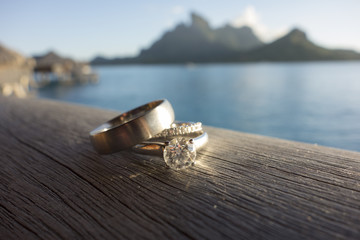 Wedding rings with tropical vacation background