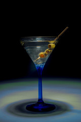 martini in a glass with olices