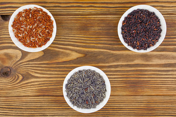 Raw blue rice in bowl on  wooden background