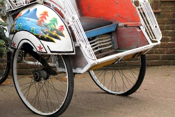 Beautiful ornately decorated rickshaw bicycle seat and wheels