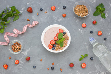 Diet  concept flat lay porridge, nuts, fresh berries and bottle of water. Top view. 