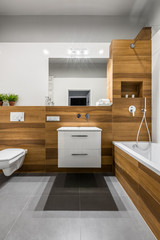 Wooden bathroom with bathtub