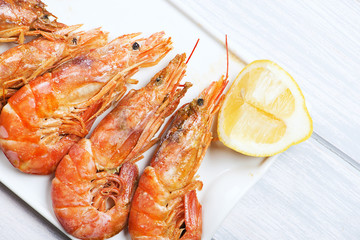 Close-up of shrimps served with lemon. Copy space. Seafood.