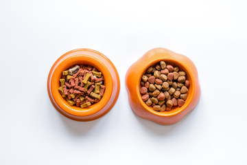 dry pet food in bowl on white background top view