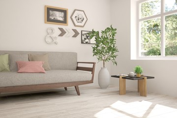 White room with sofa and green landscape in window. Scandinavian interior design. 3D illustration