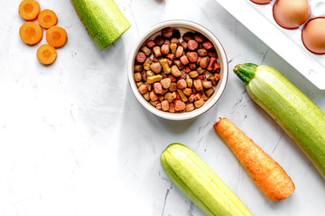 petfood set with vegetables and eggs on kitchen table top view m
