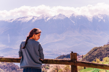 Outdoor lifestyle image, portrait of pretty woman posing at amazing mountains background