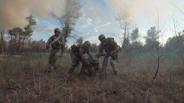 Soldiers getting injured while shooting and having contact on battlefield.