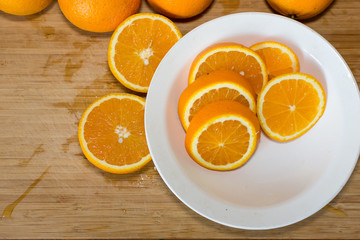 Oranges on a table and on a white plate