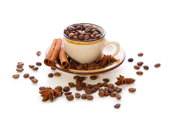 Coffee beans in a cup and cinnamon