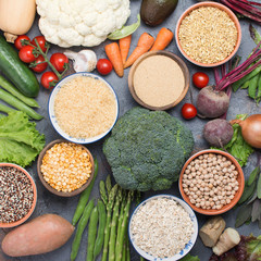 Fototapeta na wymiar Top view of grains in bowls and vegetables, broccoli, squash, beans, tomatoes, carrots, avocado, quinoa, peas, rice, oats, selective focus