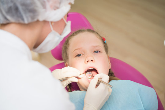 Dental exam , small girl in dental clinic