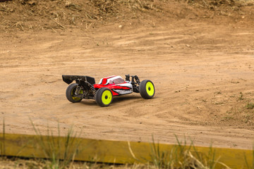 Radio controlled car model in race on dirt track