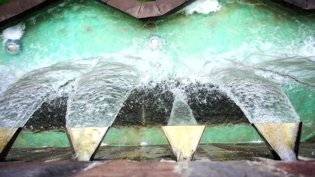 Water running on modern fountain. Slow motion.	