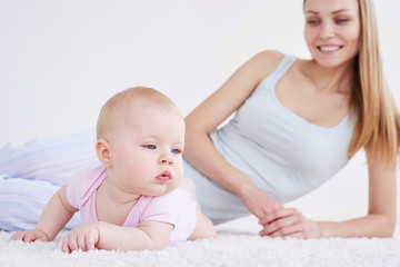 Mother and a child lying on a carpet