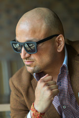 portrait of a hansome indian businessman in sunglasses, serious and confident man