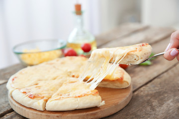 Tasty sliced pizza on wooden table