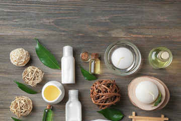 Spa composition with tea tree oil on wooden background