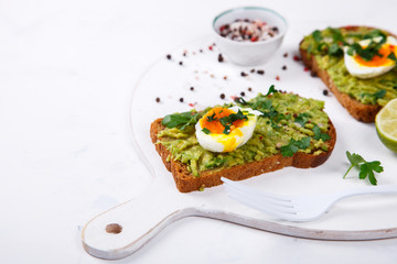 Avocado Vegetable. Sandwiches with Guacamole ,Egg and Parsley on a White Background.Appetizer.Food or Healthy diet concept.Copy space for Text. selective focus.