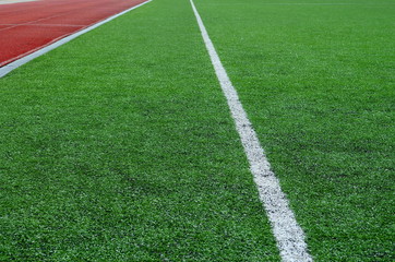 Obraz premium football field with artificial turf with white diagonal lines, background
