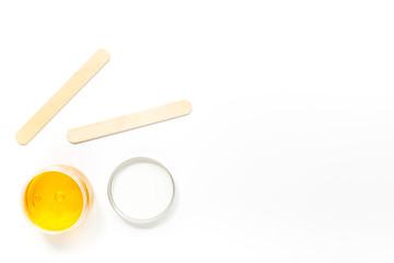 Wax and sticks for depilation on white background top view copyspace