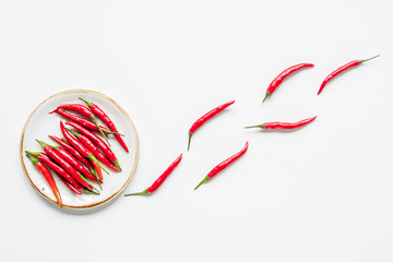 red hot chili pepper design on white table background top view