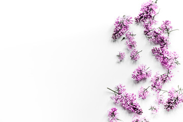 Spring lilac flowers on workdesk female home office white background top view mockup