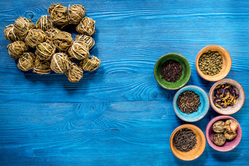 Different kinds of herbal tea on blue background top view mockup