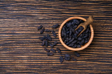 black raisins in bowl on table