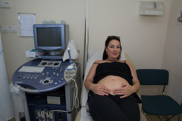 Pregnant woman has her ultra sound check up. happy pregnant woman on ultra sound