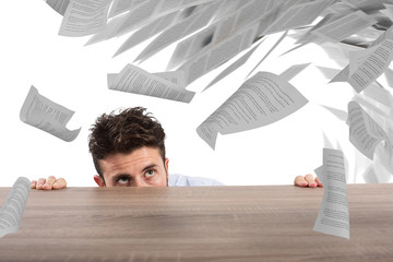 Businessman afraid under the desk. concept of overwork