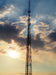 Obraz premium COMMUNICATION TOWER WITH EPIC SUNSET CLOUDY SKY