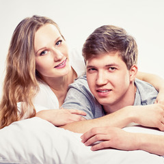 Obraz na płótnie Canvas portrait of Couple hugging in bed