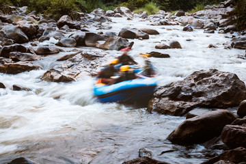 Motion blur of young person rafting on the river, extreme and fun sport at tourist attraction