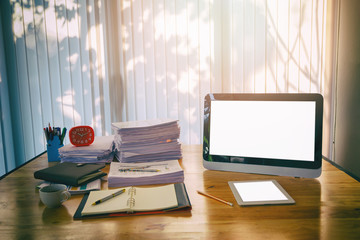 Fototapeta premium Wooden table with office supplies in home office at morning